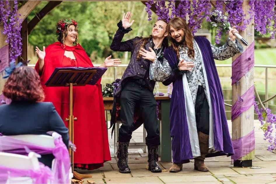Celebrant in red gown with two cos play grooms