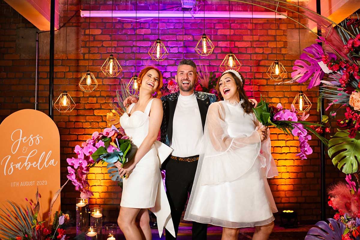Colourful Celebrant with two happy brides